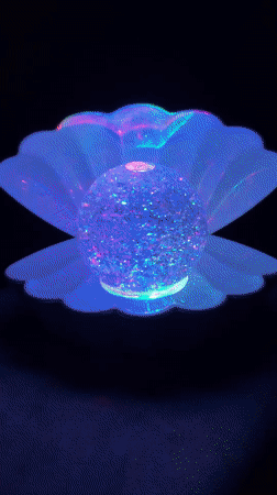 Glitter-orb seashell lamp glowing in València at night