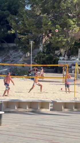 Beach volleyball and yacht life on a sunny Palmanova afternoon