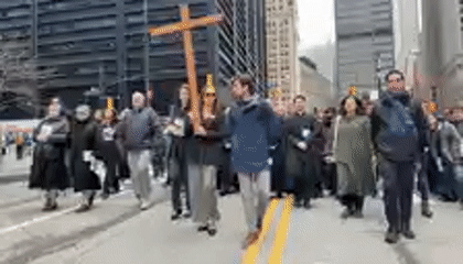 Religious procession with wooden cross near NYC City Hall