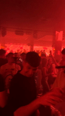 Nightclub scene captured in Sofia with red lighting, crowds
