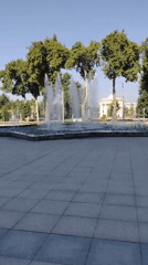 Fountain running in a tidy urban plaza on a sunny day