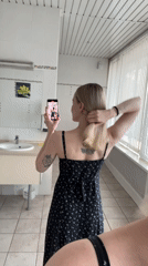 Woman photographs herself indoors and outdoors in Khimki