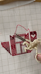 Evening craft session captured in Birobidzhan with embroidery and cat