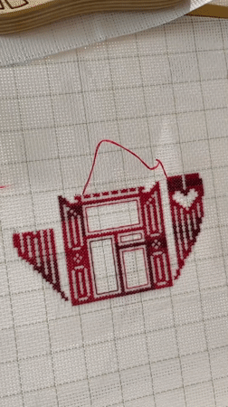 Evening craft session captured in Birobidzhan with embroidery and cat