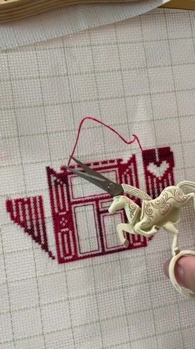 Evening craft session captured in Birobidzhan with embroidery and cat