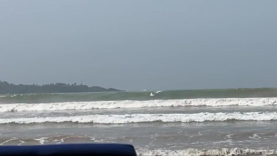 Surfers brave foggy conditions in Weligama waters