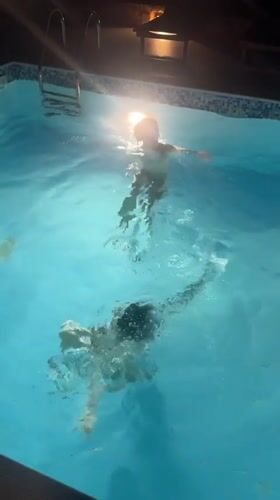 Evening pool gathering captured in Kokkino Chorio, Greece