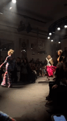 Fashion show featuring elaborate colorful designs held in London