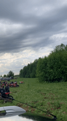 Early morning motorcycle gathering in Russian field draws riders, spectators