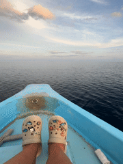 Tourist relaxes on boat near Ukulhas, Maldives