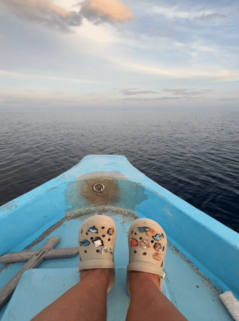 Tourist relaxes on boat near Ukulhas, Maldives