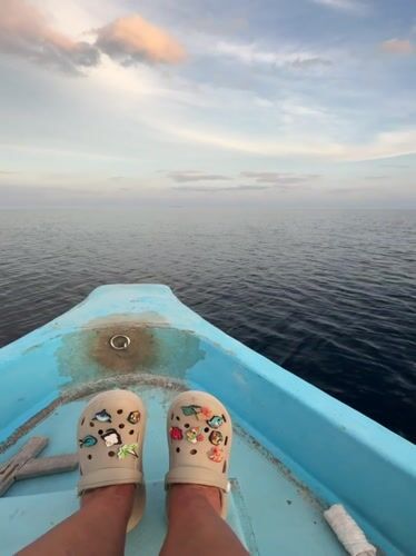 Tourist relaxes on boat near Ukulhas, Maldives