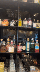 Person films liquor display with decorative bottle in Sofia