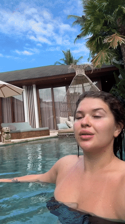 Woman enjoys late-night swim in Ubud pool