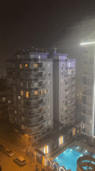 Evening domestic moments captured during rainy night in urban setting