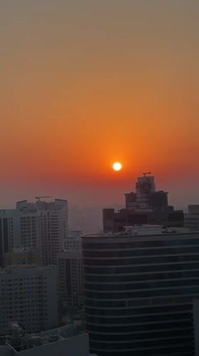 Dubai skyline glows under a hazy summer sunset