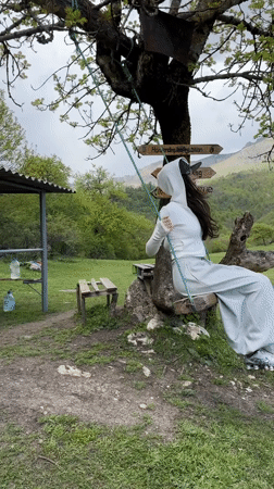 Woman enjoys tree swing at scenic Teghut location