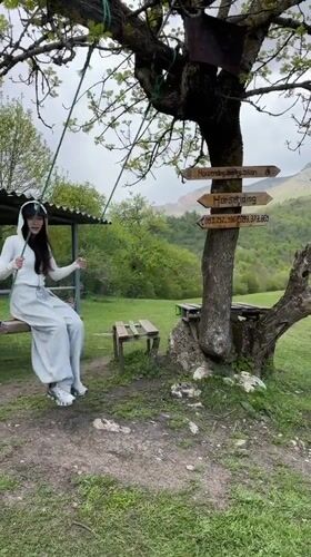 Woman enjoys tree swing at scenic Teghut location