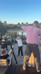 Outdoor gathering at a riverside property in Karsha, Russia
