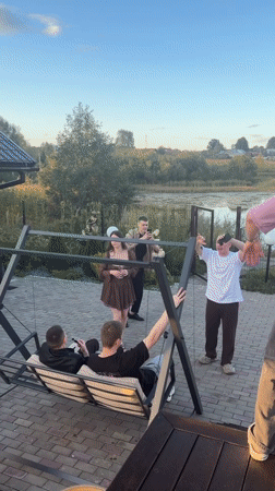 Outdoor gathering at a riverside property in Karsha, Russia