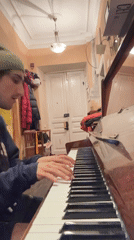 Young man performs piano and vocals in Moscow room