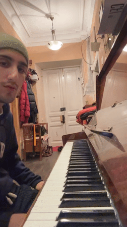Young man performs piano and vocals in Moscow room
