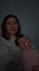Woman and child seated together indoors in Moscow evening