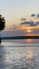 Woman paddleboards at sunset in Chaikovsky, Russia