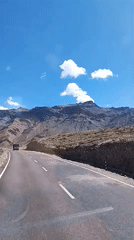 Winding mountain road under clear skies in northern India