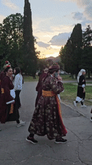 Traditional costume procession observed in outdoor setting