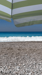 Colorful paragliders soar over sunny Fethiye beach morning