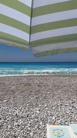 Colorful paragliders soar over sunny Fethiye beach morning