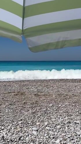 Colorful paragliders soar over sunny Fethiye beach morning