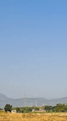 Ornate mosque and minaret rise above dry grasslands in Baujeng