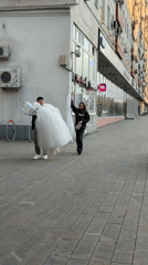 Wedding dress transported on Moscow sidewalk