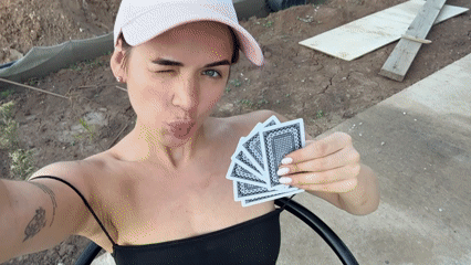 Woman plays cards outdoors in rural Russia