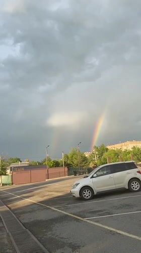 Double rainbow appears over Artyom, Russia parking area