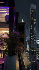 Bangkok skyline at night from a rooftop terrace