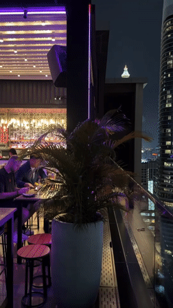 Bangkok skyline at night from a rooftop terrace