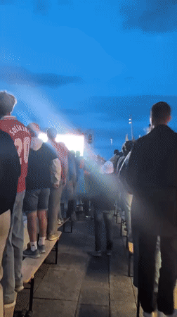 Outdoor crowd watches live sport on big screen in Stavanger