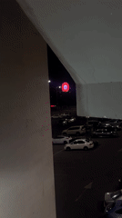 Nighttime scenes captured from Yerevan parking structure show illuminated Ferris wheel