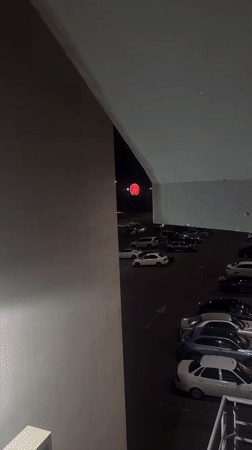 Nighttime scenes captured from Yerevan parking structure show illuminated Ferris wheel