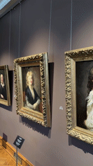Inside a classical European museum's painted galleries and ornate rooms.