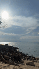 Beach scenes and local store documented in Thai coastal village