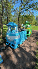 Park carnival event features miniature trains, inflatable slides