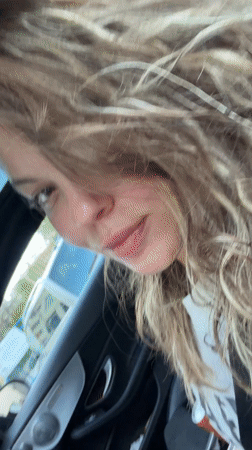 Woman takes selfies in Mercedes on Varna street