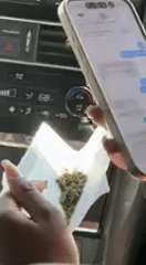 Person uses messaging app on phone inside car in Whitewater