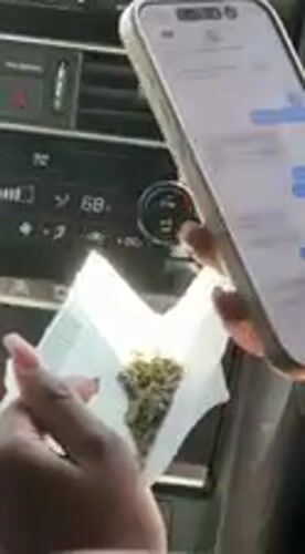 Person uses messaging app on phone inside car in Whitewater