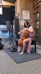Outdoor cello performance with florals and a cold drink nearby