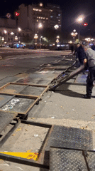 Metal barricades block Buenos Aires crosswalk at night